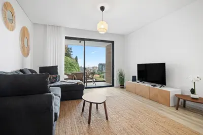 a living room with a couch and a tv and a table at MK Apart I in Funchal