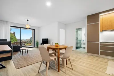 a dining room and living room with a table and chairs at MK Apart I in Funchal