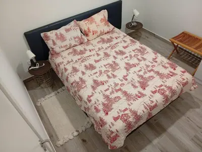 a bedroom with a bed with a red and white blanket at Danny's Rural Suite T2 in Curral das Freiras