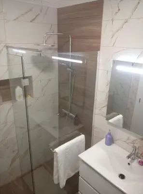 a bathroom with a glass shower and a sink at Danny's Rural Suite T2 in Curral das Freiras
