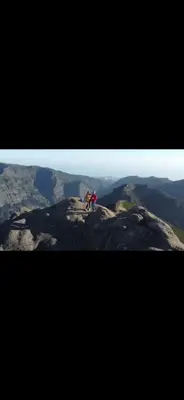 two people standing on top of a mountain at Danny's Rural Suite T2 in Curral das Freiras