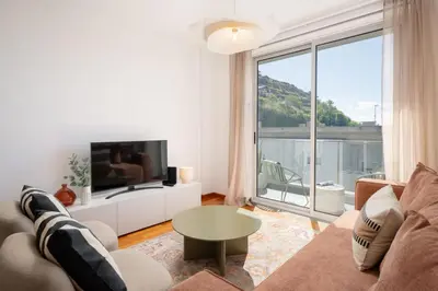 a living room with a couch and a large window at Wings Apartment II by An Island Apart in Santa Cruz