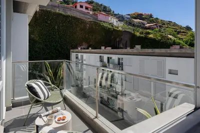 a balcony with a table and chairs on a building at Wings Apartment II by An Island Apart in Santa Cruz