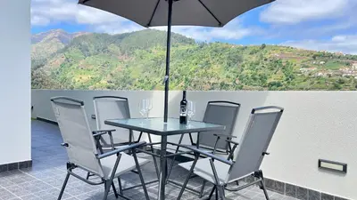 a bench sitting on the balcony of a house at The Barreto's Clive in Ponta do Sol