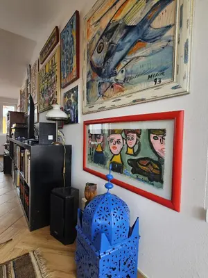 a living room with paintings on the wall at Talefe Apartment in Luz