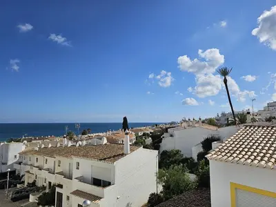 a view of the ocean from the roofs of buildings at Talefe Apartment in Luz