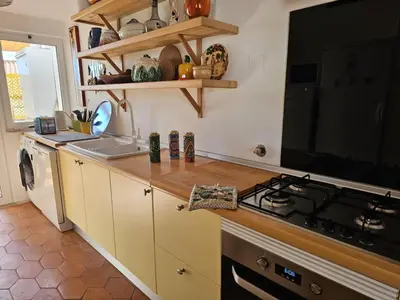 a kitchen with a sink and a stove top oven at Talefe Apartment in Luz