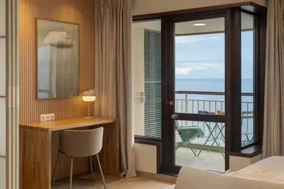 a room with a desk and a view of the ocean at Monumental Studio 10 by An Island Apart in Funchal