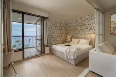 a bedroom with a bed and a large window at Monumental Studio 10 by An Island Apart in Funchal