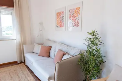 a white couch in a living room with a plant at Casa Calma II - 2 double bedrooms apartment in Luz