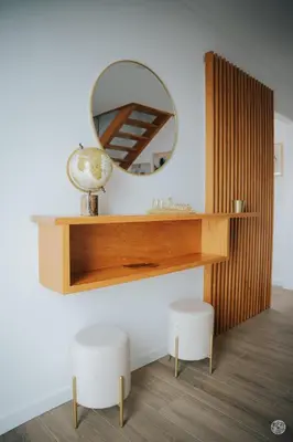 a mirror on a wall with a vanity and two stools at Casa da Carreira in Almagreira