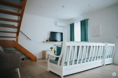 a white crib in a room with a staircase at Casa da Carreira in Almagreira