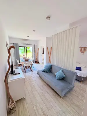 a living room with a couch and a bedroom at Magnolia Studio 303 in Lagos