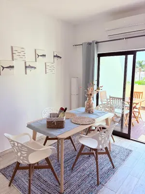 a dining room with a table and chairs at Magnolia Studio 303 in Lagos