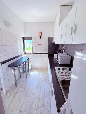 a kitchen with a table in the middle of it at Magnolia Studio 303 in Lagos