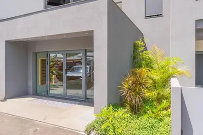 a facade of a building with a glass door at FLH Funchal Seaside at Acqua Residences in Funchal
