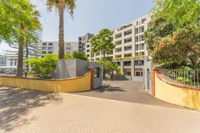 an empty street with a building in the background at FLH Funchal Seaside at Acqua Residences in Funchal