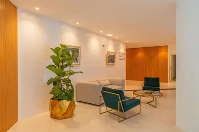 a waiting room with a couch and a potted plant at FLH Funchal Seaside at Acqua Residences in Funchal