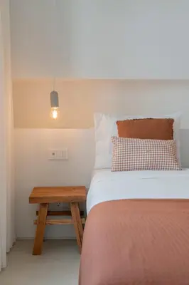 a bedroom with a bed and a wooden table at In Funchal city centre - AL'gria II in Funchal