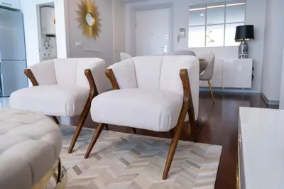 a living room with two white chairs and a table at Lux City Center Apart-Free Park EU in Funchal