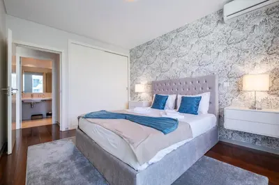 a bedroom with a large bed with blue pillows at Lux City Center Apart-Free Park EU in Funchal