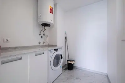 a white laundry room with a washing machine in it at Lux City Center Apart-Free Park EU in Funchal