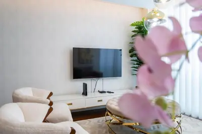 a living room with two chairs and a flat screen tv at Lux City Center Apart-Free Park EU in Funchal