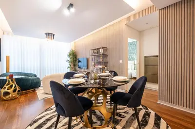 a living room with a dining table and chairs at Lux City center apartments EX in Funchal