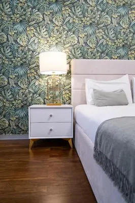 a bedroom with a bed and a nightstand with a lamp at Lux City center apartments EX in Funchal