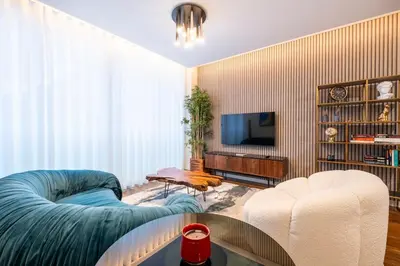 a living room with a couch and a tv at Lux City center apartments EX in Funchal