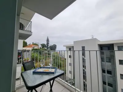a balcony with a table with wine glasses on it at Blue Sky by Susys Holidays in Funchal