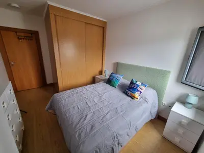a bedroom with a bed and a wooden door at Blue Sky by Susys Holidays in Funchal
