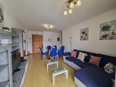 a living room with a blue couch and a table at Blue Sky by Susys Holidays in Funchal