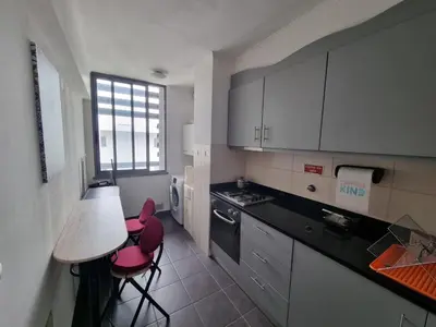 a kitchen with two red chairs and a table at Blue Sky by Susys Holidays in Funchal