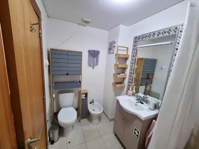 a bathroom with a toilet and a sink and a mirror at Blue Sky by Susys Holidays in Funchal