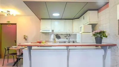 a kitchen with white cabinets and a counter top at By the Sea VI - Marina in Funchal