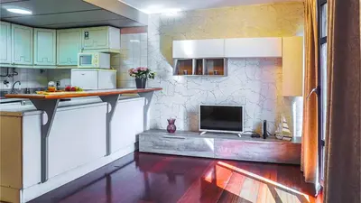 a kitchen with a counter with a tv in it at By the Sea VI - Marina in Funchal
