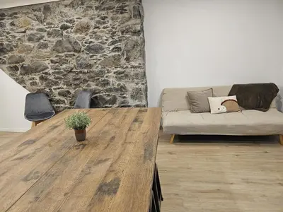 a living room with a wooden table and a couch at Villa Júlia, Mountain retreat in Santa Cruz