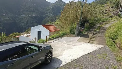 a car parked next to a house on a mountain at Villa Júlia, Mountain retreat in Santa Cruz