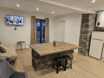 a kitchen with a large island in a living room at Villa Júlia, Mountain retreat in Santa Cruz