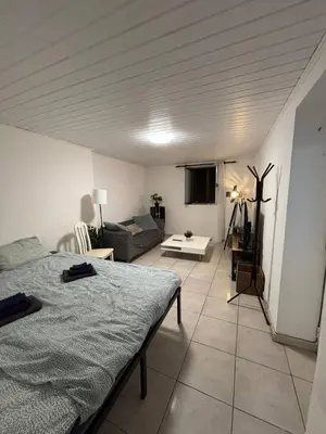 a living room with a bed and a couch at Santo Antonio 2 Schlafzimmer Apartment in Funchal