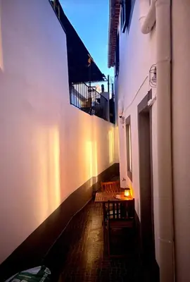 a hallway with two chairs and a table in a building at Santo Antonio 2 Schlafzimmer Apartment in Funchal