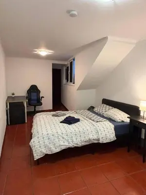 a bedroom with a bed and a television in it at Santo Antonio 2 Schlafzimmer Apartment in Funchal