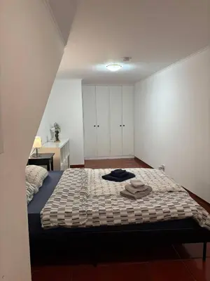 a bedroom with a bed with towels on it at Santo Antonio 2 Schlafzimmer Apartment in Funchal