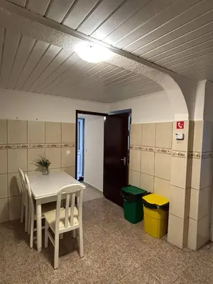 a room with a table and chairs and a door at Santo Antonio 2 Schlafzimmer Apartment in Funchal