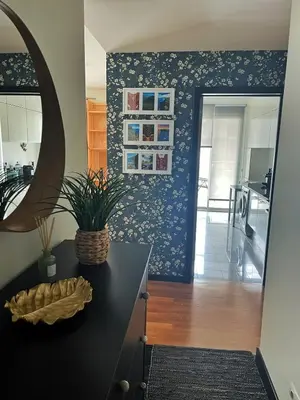 a kitchen with a black counter and a blue wall at Rodamar Apartment Forum Funchal in Funchal