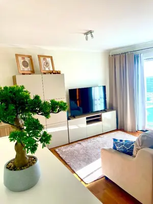 a living room with a couch and a tree at Rodamar Apartment Forum Funchal in Funchal