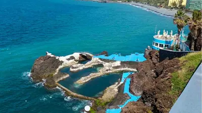 an island in the ocean with a ferry at Rodamar Apartment Forum Funchal in Funchal