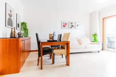 a living room with a table and a couch at Ivory Breeze by Elysian in Funchal