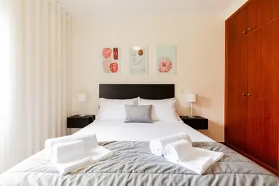 a bedroom with a large bed with two white pillows at Ivory Breeze by Elysian in Funchal